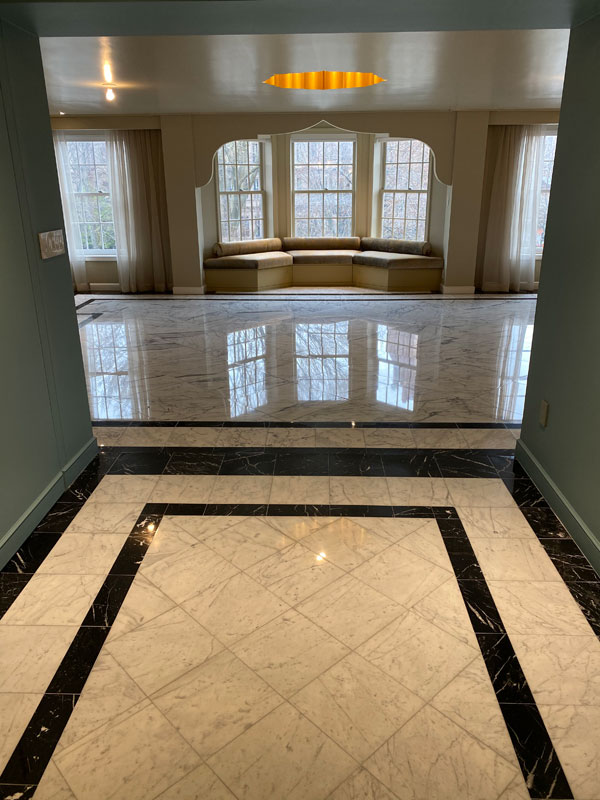 a marble surface that has been restored to a high shine. The surface has a glossy, reflective finish and appears smooth and free of scratches or blemishes